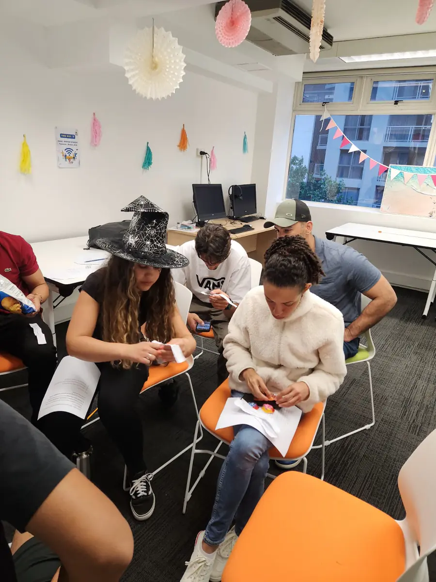 Halloween classroom activity, 2025 Students in Halloween costumes completing a classroom worksheet activity