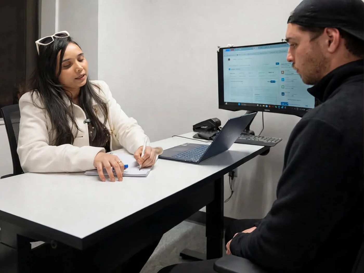 Teacher reviewing a student's work A student and a teacher working together at a computer at Boston Institute