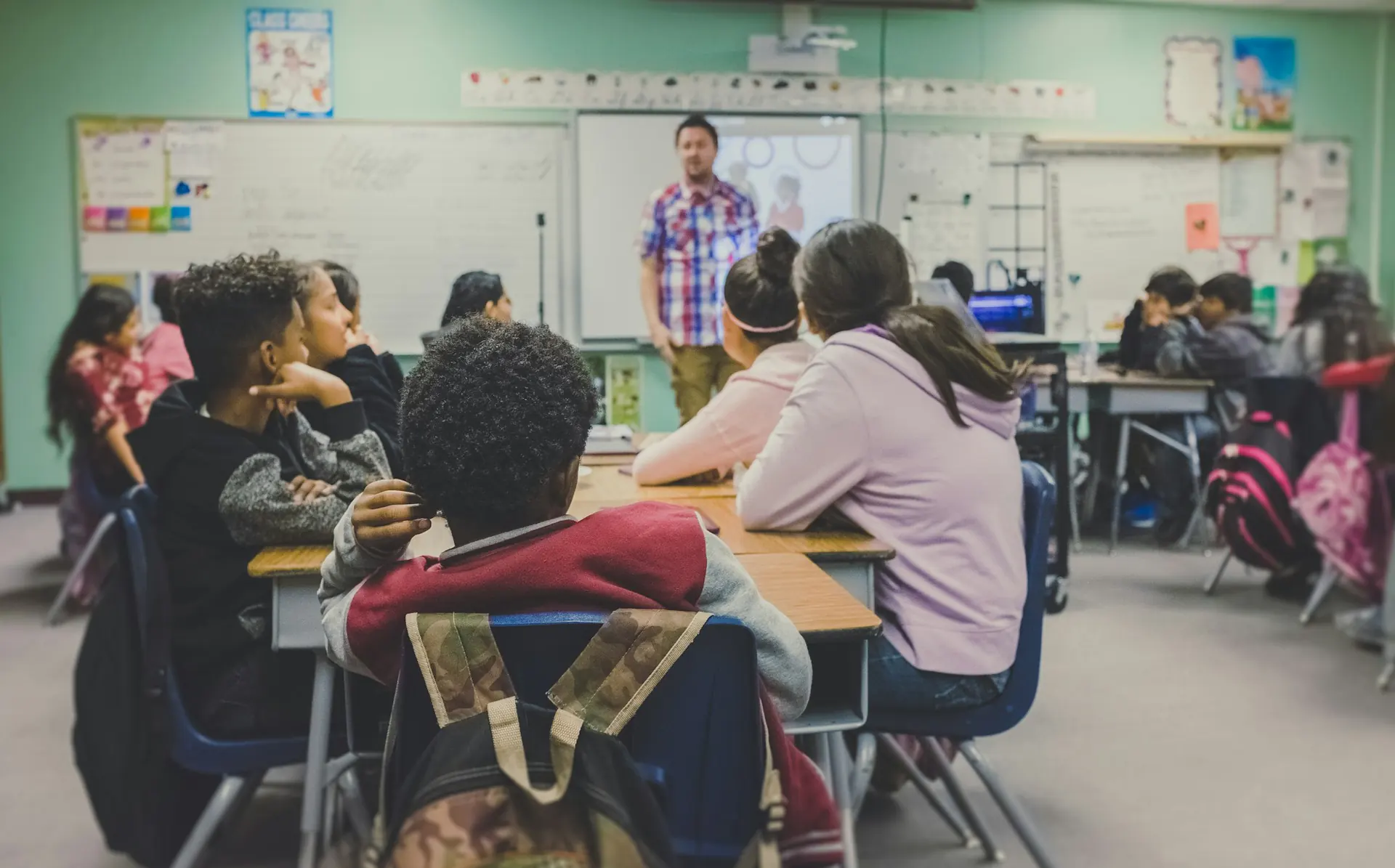 Classroom with students Teacher standing at the front of a classroom full of students