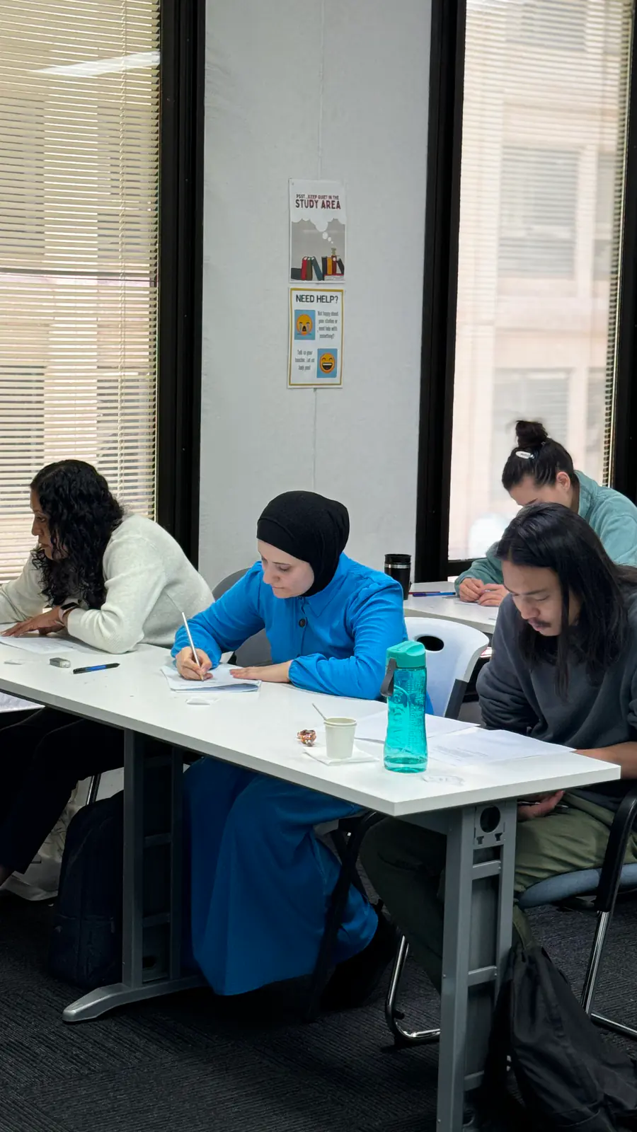 Classroom group work Boston Institute students working together at a table in class