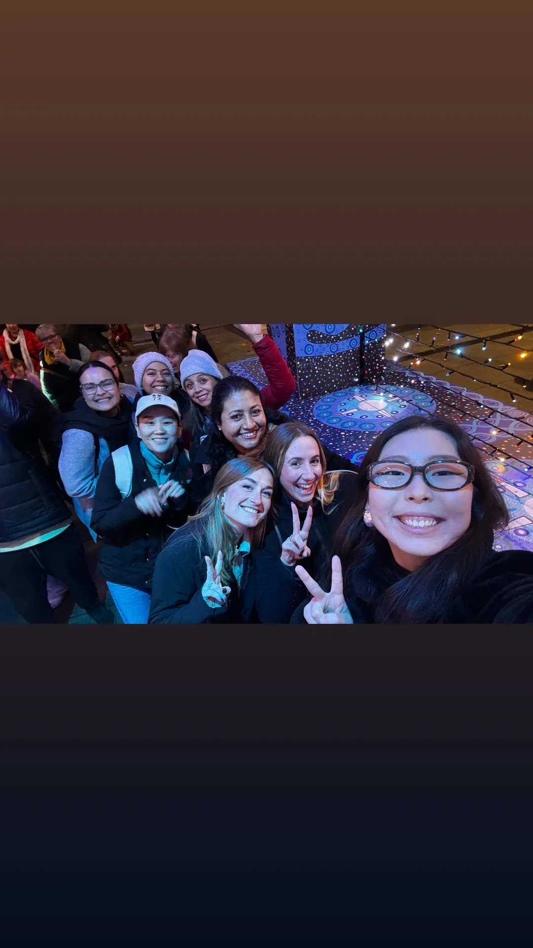 Evening group selfie Boston Institute students taking a group selfie during an evening excursion