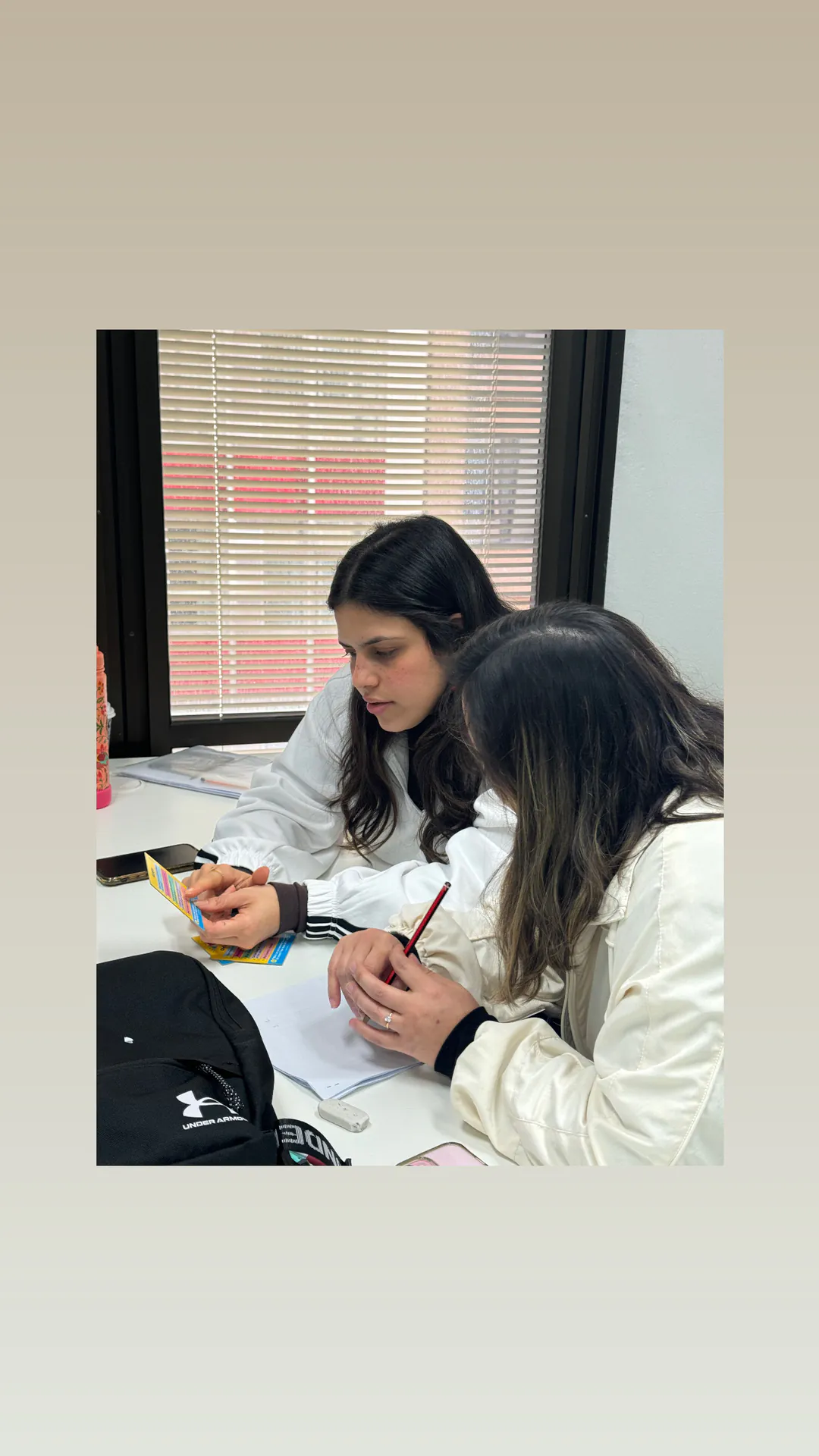 Students studying together Two Boston Institute students studying together at a classroom desk