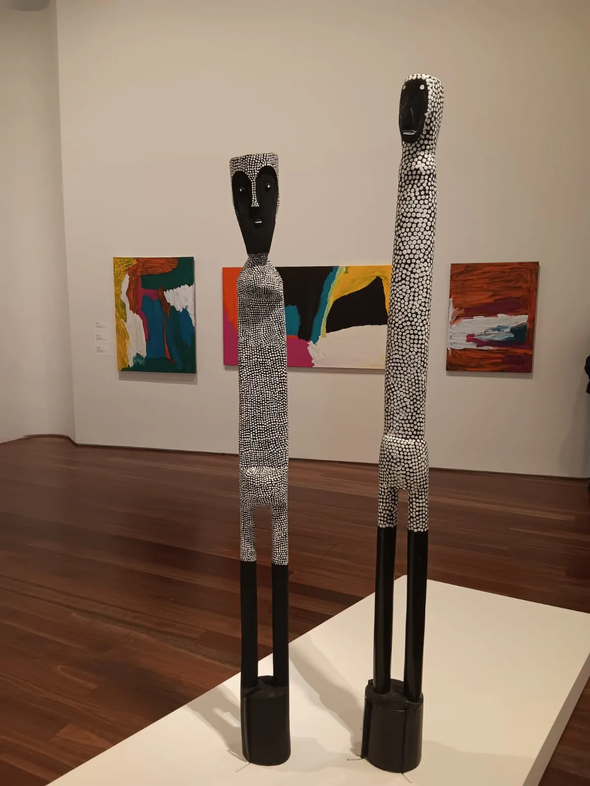 Gallery sculpture display Tall carved figure sculptures on display at a Sydney art gallery
