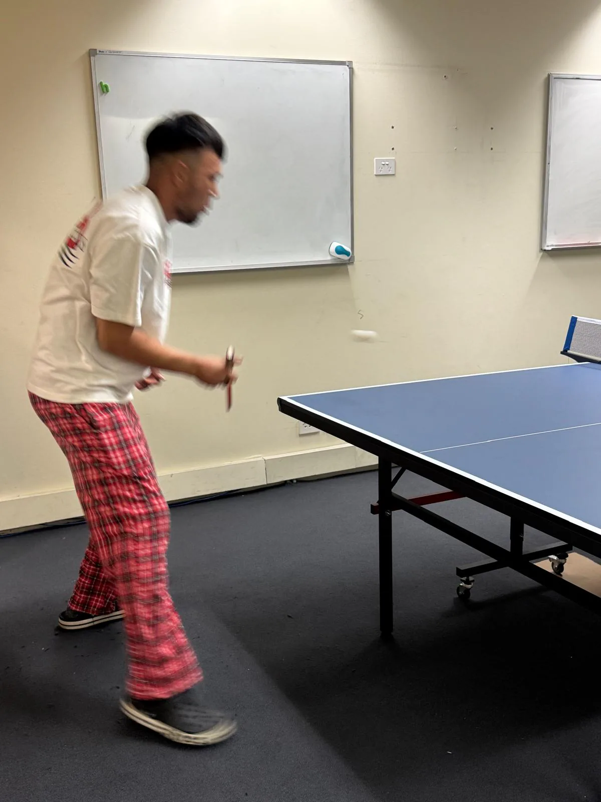 Table tennis match, 2025 Student playing a table tennis match at the Boston Institute campus