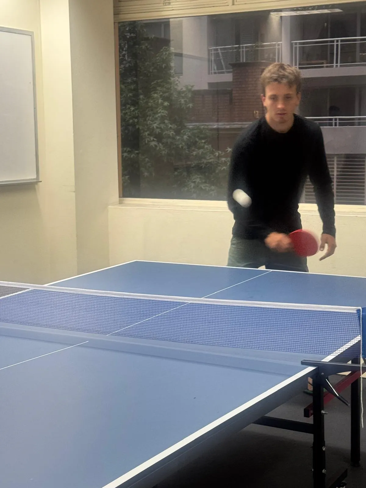 Return shot, 2025 Student playing a return shot during a Boston Institute table tennis game