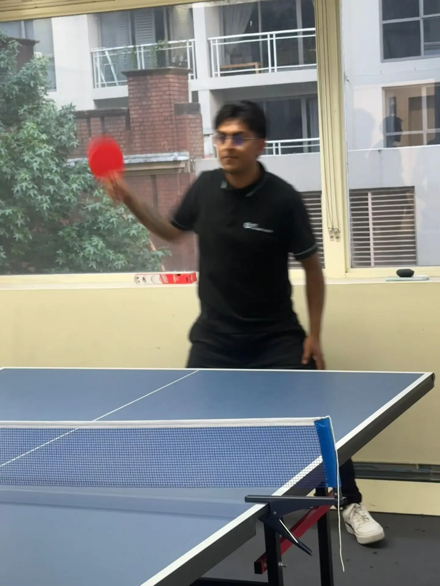 Table tennis serve, 2025 Student serving during a table tennis match at Boston Institute