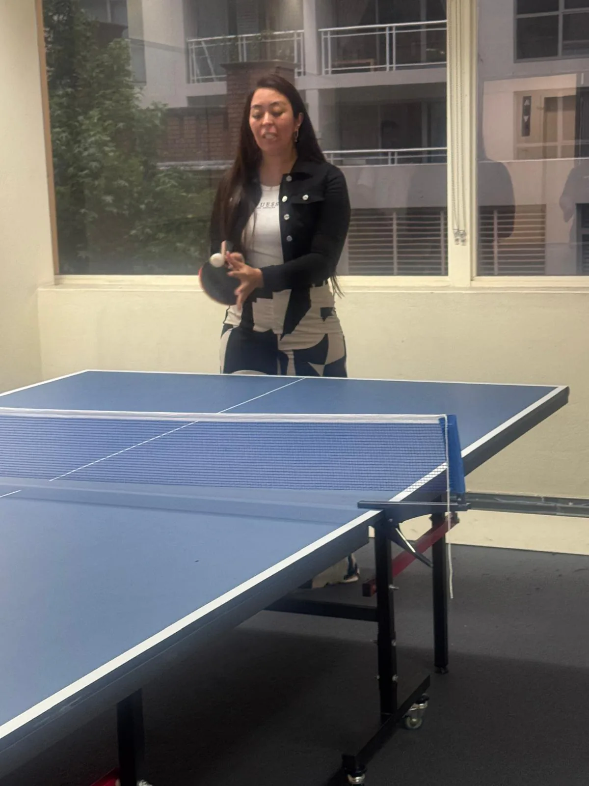 Student serving, 2025 Boston Institute student serving in a table tennis game