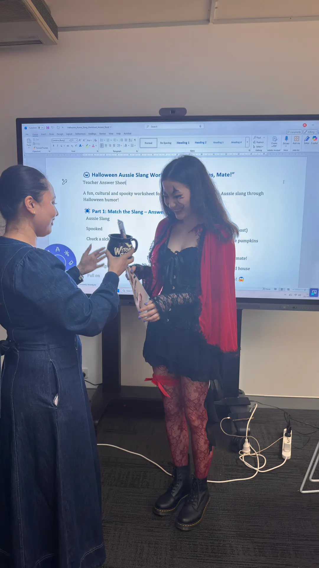 Costume prize, Halloween 2025 Boston Institute staff presenting a Halloween costume prize to a student