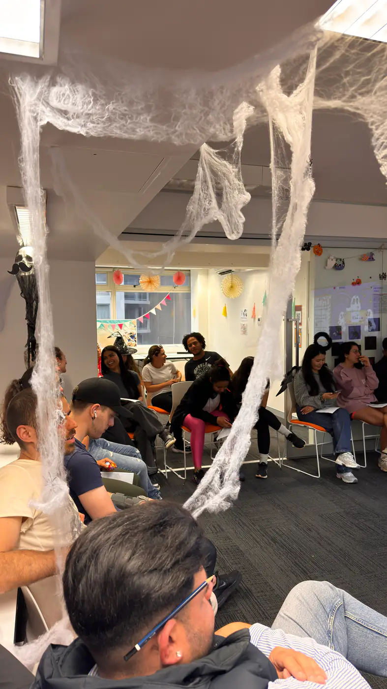 Decorated classroom, Halloween 2025 Boston Institute classroom decorated with cobwebs for Halloween, students seated inside