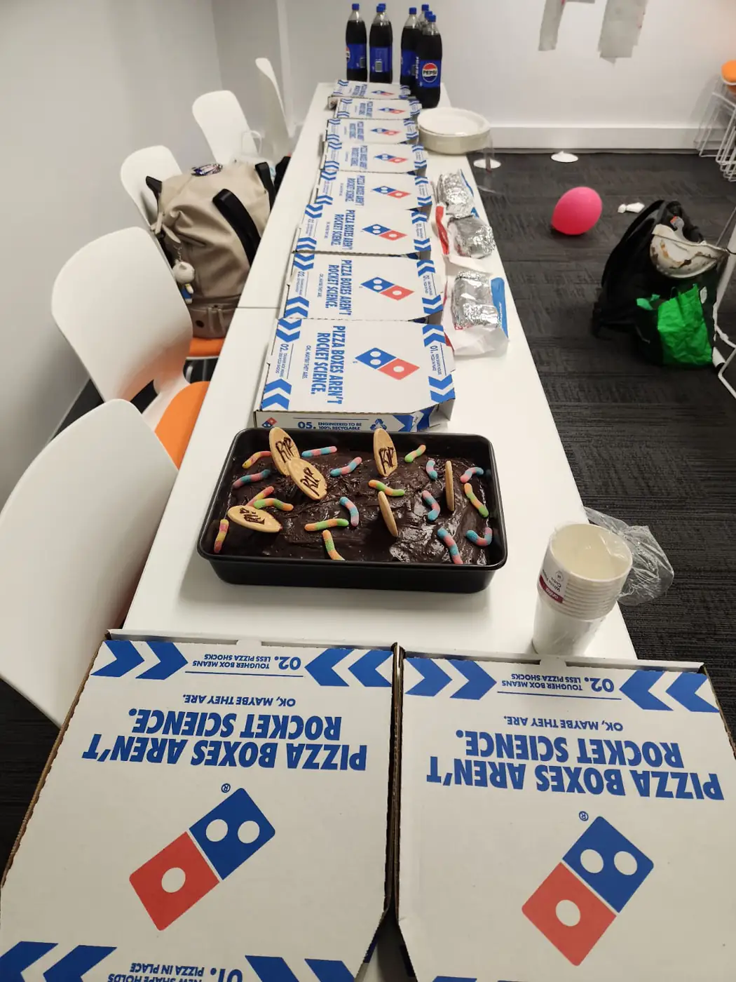 Halloween party table, 2025 Long party table set with pizza boxes and Halloween cake at Boston Institute