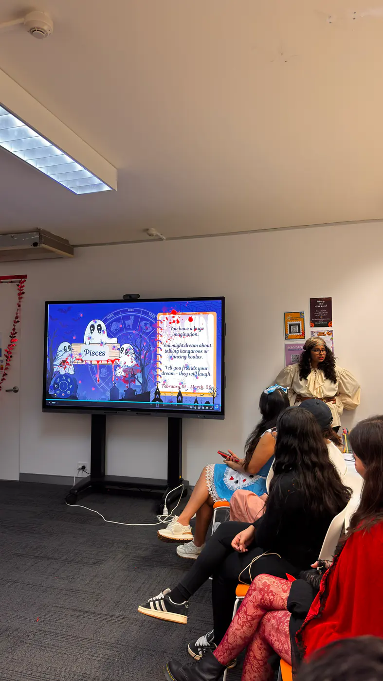 Quiz presentation, Halloween 2025 Boston Institute students watching a Halloween quiz presentation in class