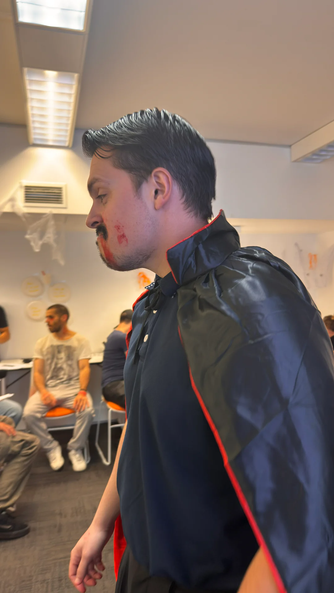 Vampire cape costume, Halloween 2025 Student wearing a vampire cape and makeup in a Boston Institute classroom