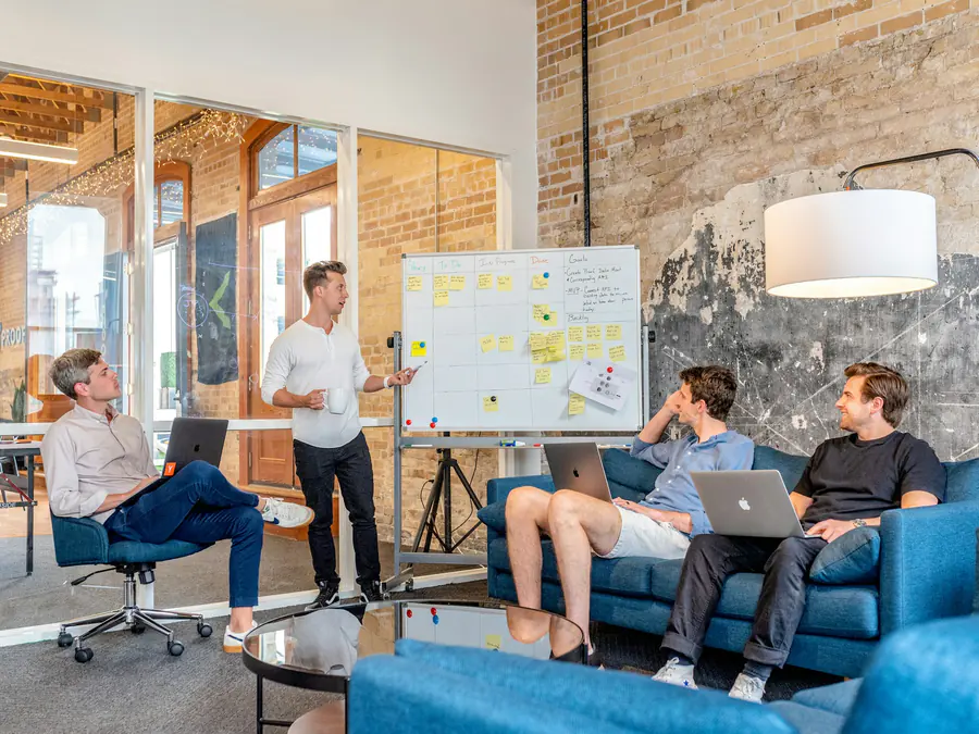Colleagues meeting in a bright modern office lounge